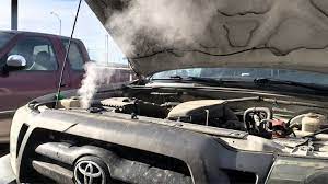 car overheating with smoke coming from the hood.